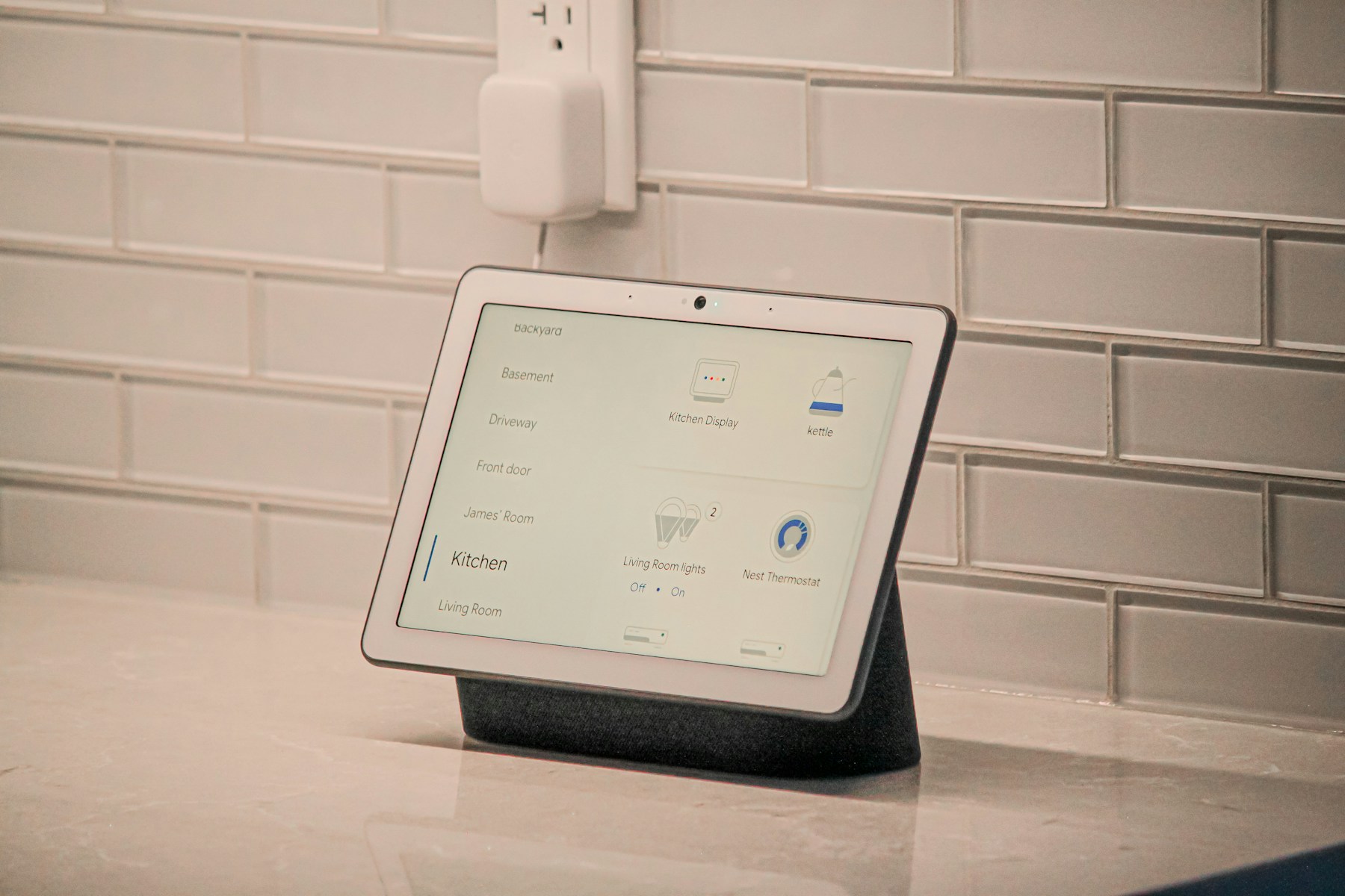 Google Nest Hub Max displaying smart-home controls on a kitchen counter.